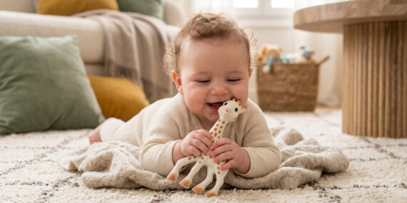 Cute baby chewing on teething ring for 2 month old